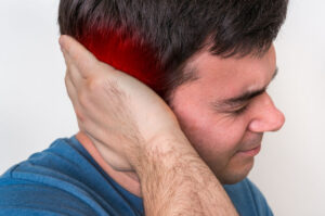 a man holds his head. 