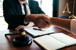 A solicitor shaking hands with a client after discussing MRSA claims. 