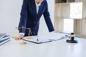A solicitor works on a car crash claim at a desk.