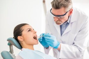 DENTIST PERFORMING DENTAL TREATMENT ON A PATIENT