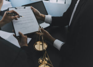 Two solicitors looking at a document on a clipboard.