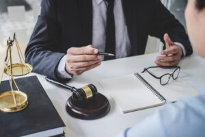 A solicitor at their desk explaining how to sue for laser hair removal burns to their client.