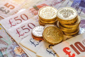 A pile of bank notes and coins to represent assault at work compensation.