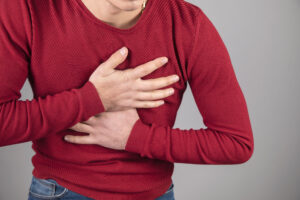 A man clutching his chest after an injury that has potentially caused broken or bruised ribs. He may start a claim for personal injury compensation