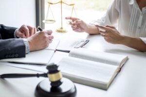 Solicitor discussing how to sue for an office accident with their client.