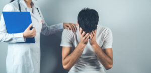 A man with mental injury and physical injuries talks with his nurse