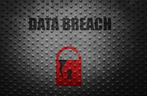 A red security lock and the word 'data breach' written on a dark grey textured background.