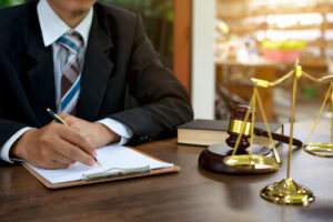 Solicitor holding pen working on how to sue for a defective product case.