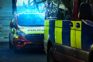 A parked police van flashes its emergency blue lights