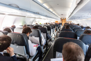 Passengers sit on an aircraft. 