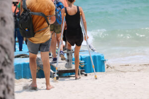 An injured holidaymaker boards a boat. 