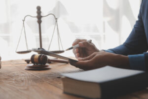 Personal injury solicitor holding pen writing about how to sue for an amputation.