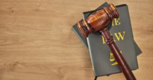 A wooden gavel on top of legal books
