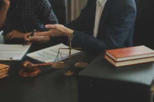 A solicitor discussing how to sue the NHS with their client during a meeting