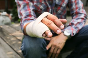 A man with his little finger and ring finger bandaged.