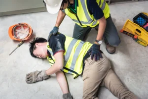 A worker in a hi vis jacket suffers injuries after an accident